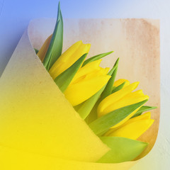 Fototapeta na wymiar Bouquet yellow tulips craft paper Parcel beige