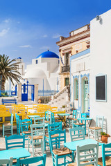 Traditional greek street with cafe tables in Serifos island, Cyclades, Greece  - obrazy, fototapety, plakaty