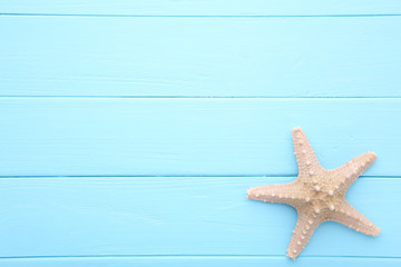 Fototapeta na wymiar Caribbean starfish on a blue wooden background.Top view
