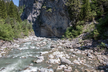 View of a wild river in a gorge in the Swiss Alps