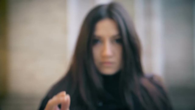 Defocused woman Gun To camera And Shooting Hand Gesture-slow motion