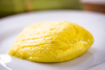 pamonha, Brazilian sweet made from homemade cheese with corn. Open pissing ready for consumption. Concept of traditional Brazilian sweet, typical food of the months of June and July.