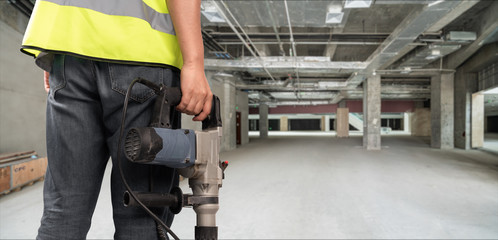 Construction Worker in front of construction site