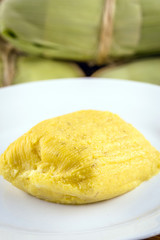 pamonha, Brazilian sweet made from homemade cheese with corn. Open pissing ready for consumption. Concept of traditional Brazilian sweet, typical food of the months of June and July.
