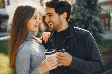 Cute couple in a spring city. Lady with long hair. Man in a black jacket