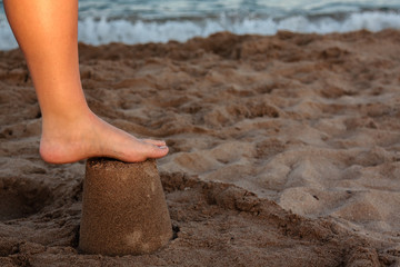 Feet on a tower of sand