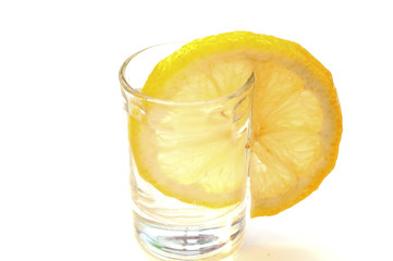 Glass of tequila and a slice of refreshing lemon