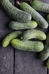 Fresh ripe cucumbers lie on the vintage table