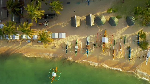 Aerial View of sand beach and lot tourist boats a on tropical Daku Island in Siargao, Philippines