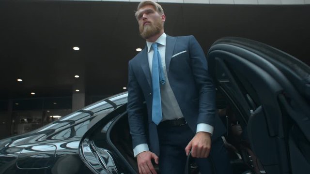 Businessman comes out of a executive car, top manager comes to the important meet, famous rich man comes out of his car with personal driver, business class car, 4k UHD Prores 422 HQ