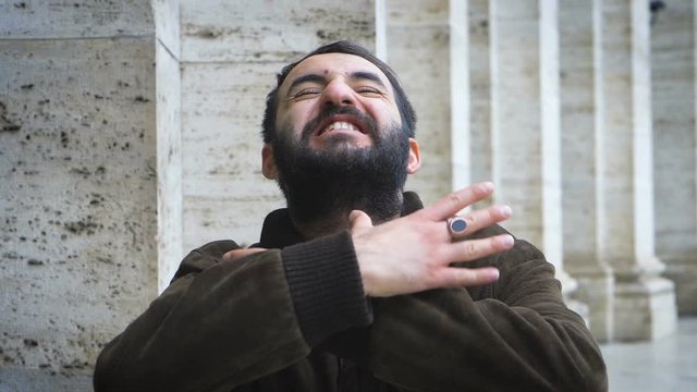 young man making the strangling gesture with his hands at the neck- slow motion