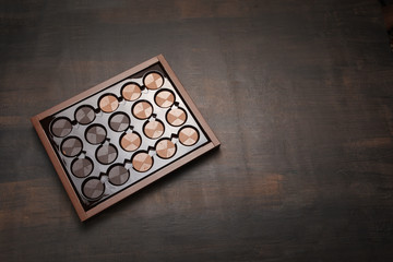 Box of chocolate on wood background with copy space