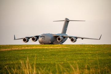 Military cargo plane parked on grassy meadow (Airport Brno, Czech Republic)