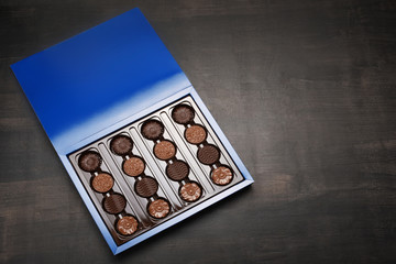 Box of chocolate on wood background with copy space