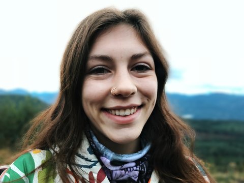 selective focus photo of woman in white and green floral top