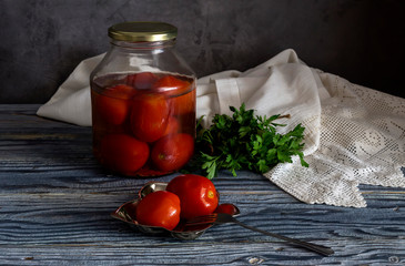 Parsley and pickled tomatoes on a wooden table