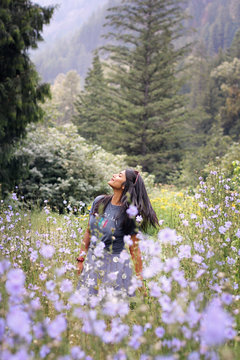standing woman near flowers during daytime