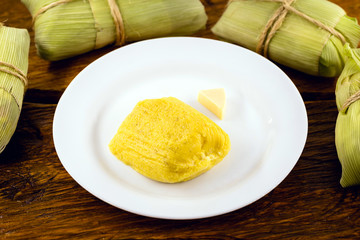 pamonha, Brazilian sweet made from homemade cheese with corn. Open pissing ready for consumption. Concept of traditional Brazilian sweet, typical food of the months of June and July.