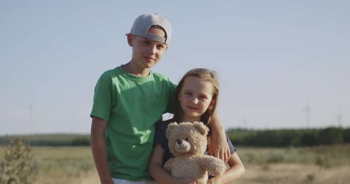 Boy and girl standing in field