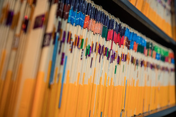 A cabinet full of files in manila folders in an office space
