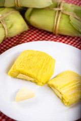 pamonha, Brazilian sweet made from homemade cheese with corn. Open pissing ready for consumption. Concept of traditional Brazilian sweet, typical food of the months of June and July.