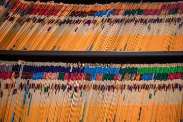 A cabinet full of files in manila folders in an office space