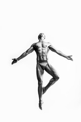 Fototapeta na wymiar Dance freedom concept. Young handsome ballet man in fly grace pose. Perfect hair & skin. Close up. Studio shot