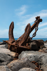 Old rusted anchor exposed on the coast