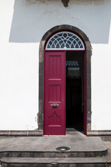 Opened burgundy door of a house