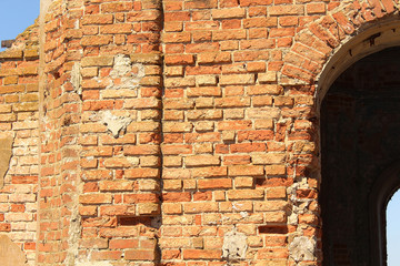 Door arch of a ruined brick building.