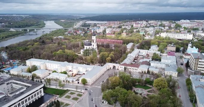 Aerial view of Orthodox Holy Trinity Cathedral on background with modern cityscape of Russian town of Kaluga in cloudy spring day