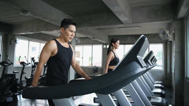 Exercise concept. Men and women are running together in the gym.