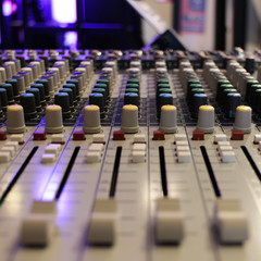 recording studio professional audio mixing console close-up, blurred