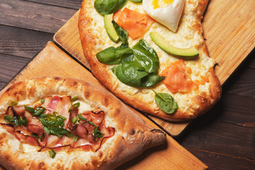 Georgian dishes khachapuri and pies on a wooden background