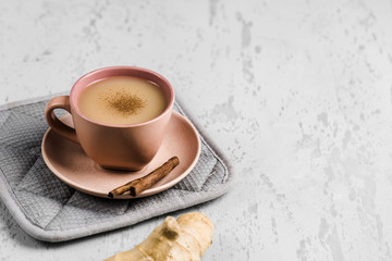 Tea masala in a Cup on the plate with the winter spices of cinnamon and ginger