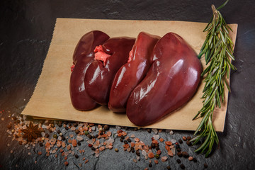 top view on group of raw pork kidneys served on craft paper