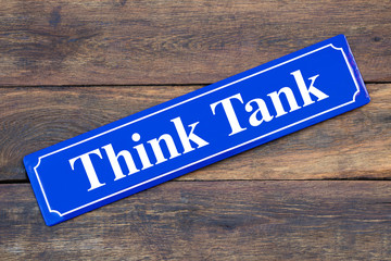 Think Tank street sign on wooden background