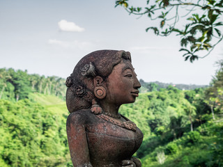 Fototapeta na wymiar traditional statue of a womens head made of stone in Bali, Indonesia
