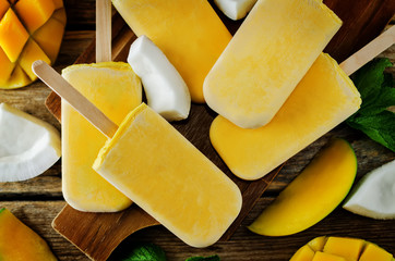 Mango coconut ice cream with fruits and mint leaves