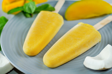 Mango coconut ice cream with fruits and mint leaves