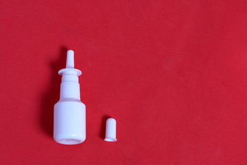 Nasal spray. Against the background of coral color. View from above.