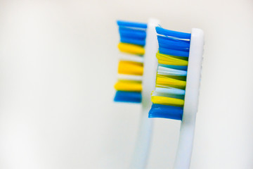 Two used toothbrushes on a white background. The concept of changing toothbrushes, oral hygiene, dentistry, friendly family with copy space.