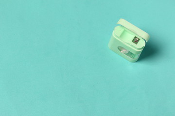 Floss container. Against the background of mint color. View from above.