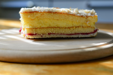 close-up homemade almond cake on a wooden board, dessert for a coffee break