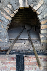 Plakat Brick oven for baking bread. The old method of baking a cake.