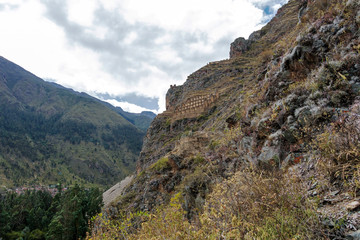 Naklejka premium Ollantaytambo ruins, a massive Inca fortress with large stone terraces on a hillside, tourist destination in Peru