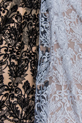 Texture lace fabric. lace on white background studio. thin fabric made of yarn or thread. a background image of ivory-colored lace cloth. White and black lace on beige background.