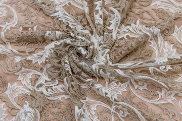 Texture lace fabric. lace on white background studio. thin fabric made of yarn or thread. a background image of ivory-colored lace cloth. White and beige lace on beige background.