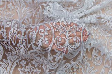 Texture lace fabric. lace on white background studio. thin fabric made of yarn or thread. a background image of ivory-colored lace cloth. White lace on beige background.