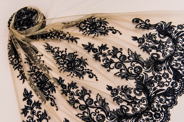 Texture lace fabric. lace on white background studio. thin fabric made of yarn or thread. a...